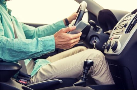 Man holding phone as he drives